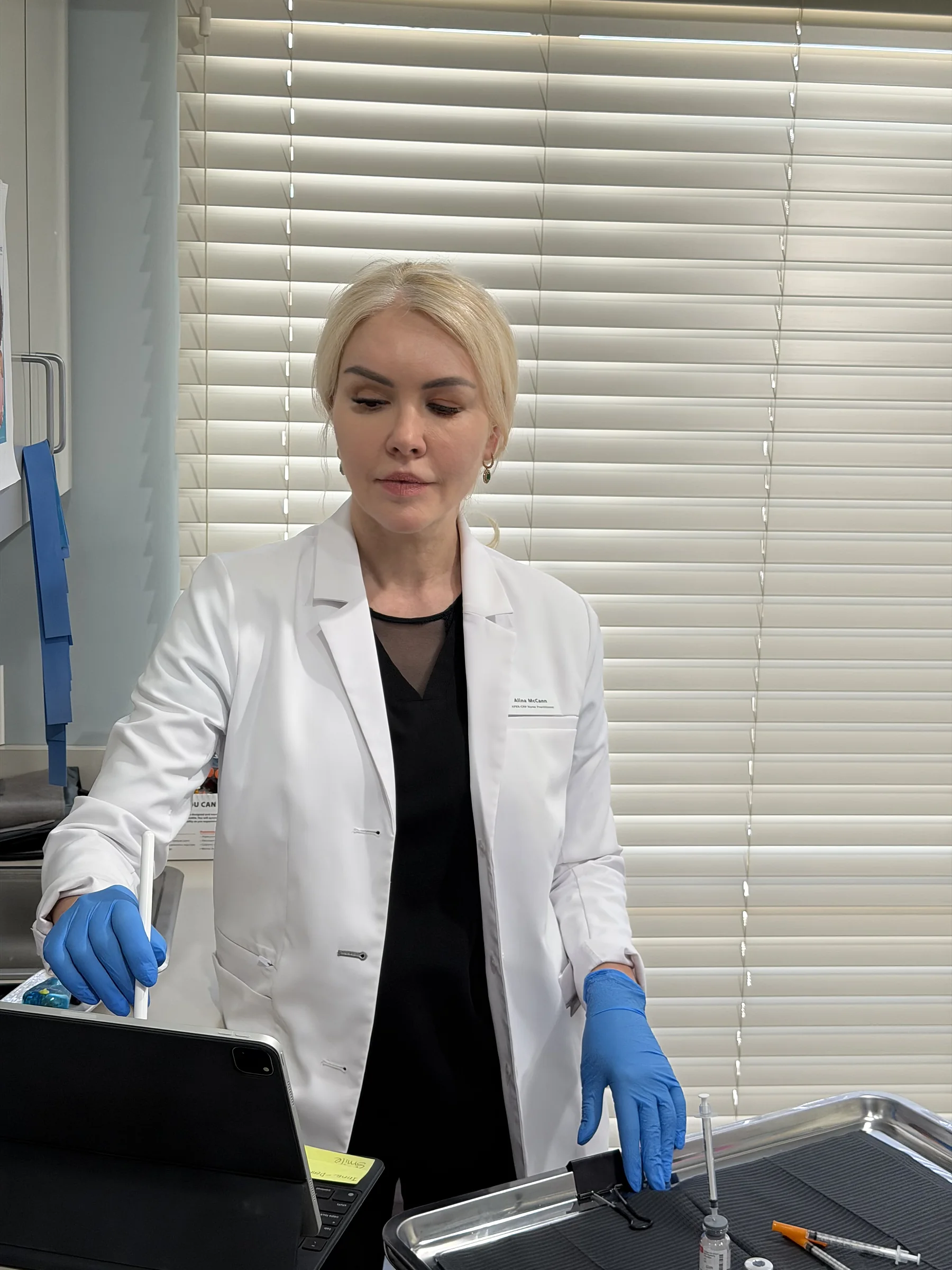 Alina McCann at the treatment-room counter