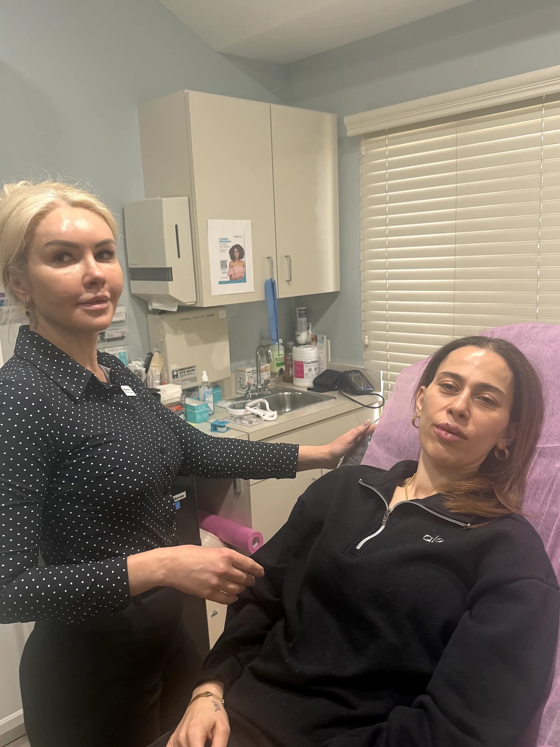Alina McCann assessing a patient's chin