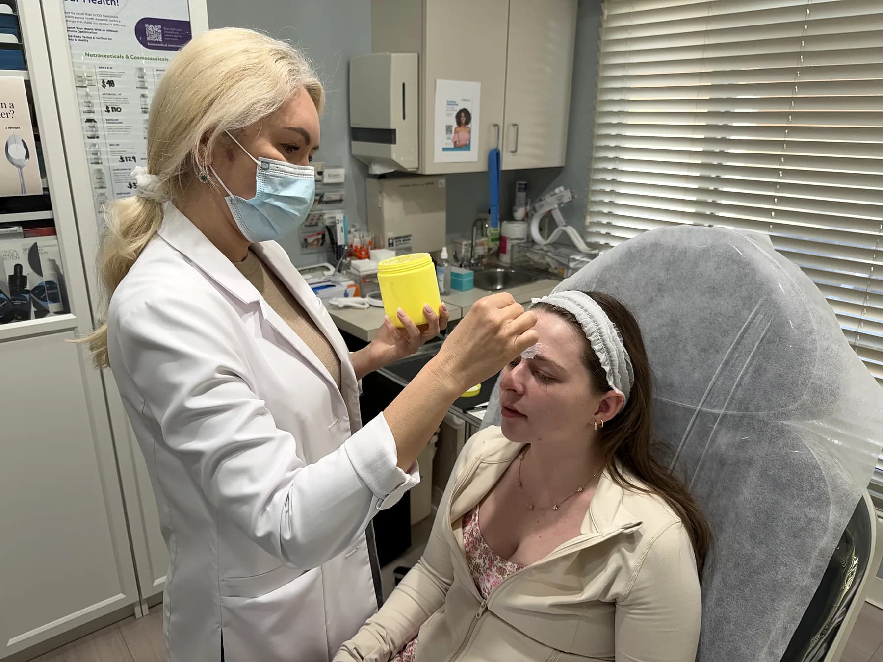 Alina McCann applying a facial treatment