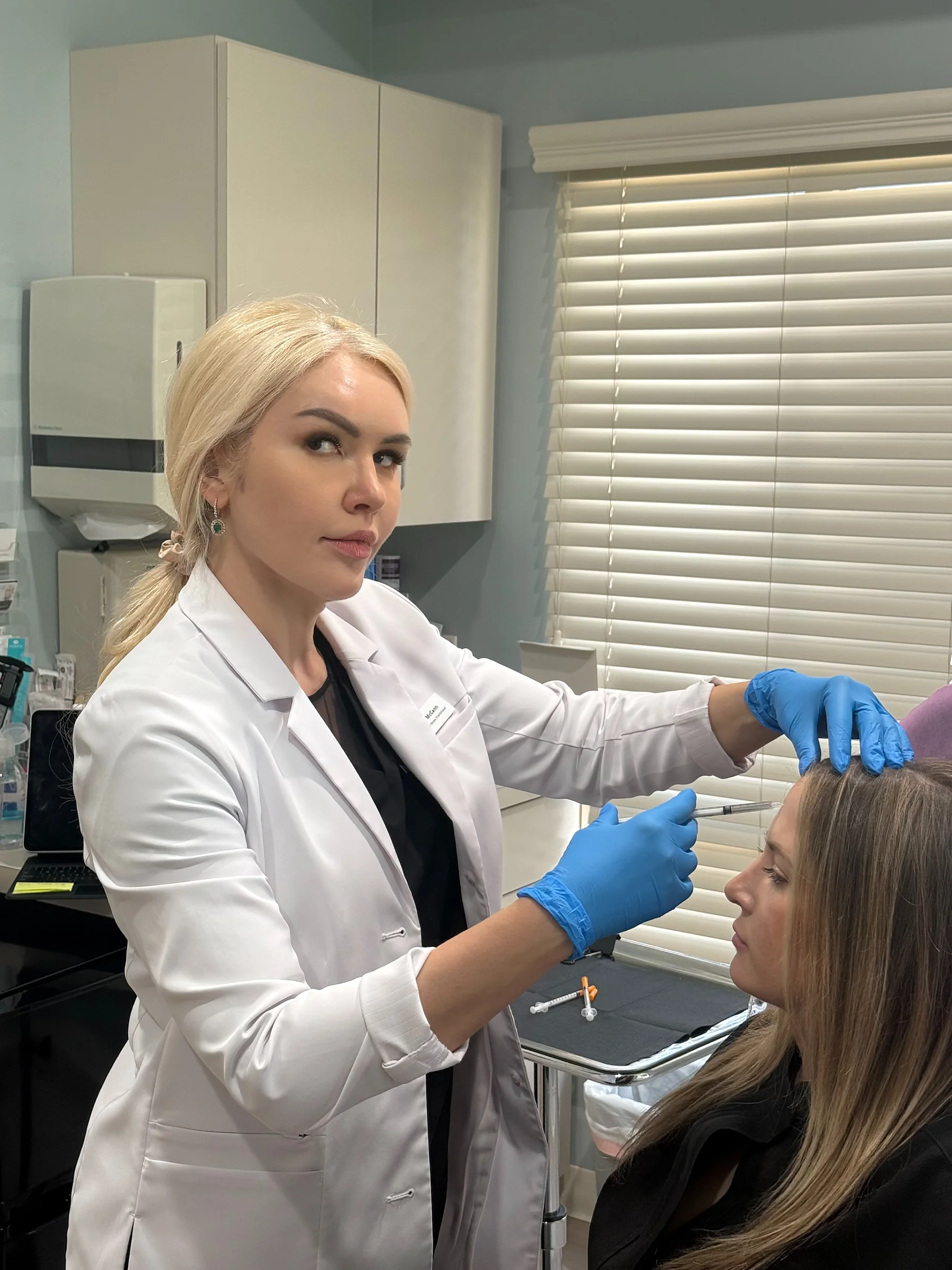Alina McCann injecting with the tray beside her