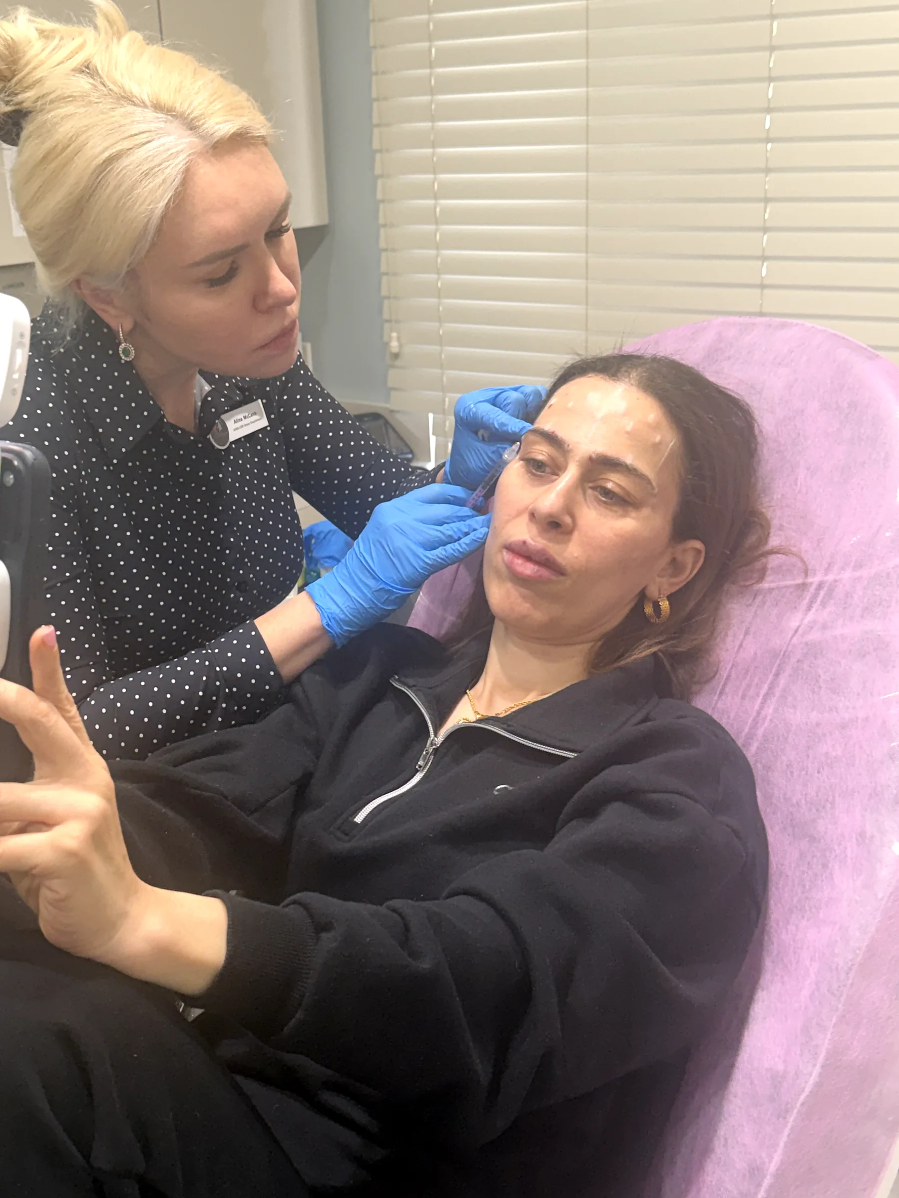 Alina McCann assessing a patient's lips before treatment