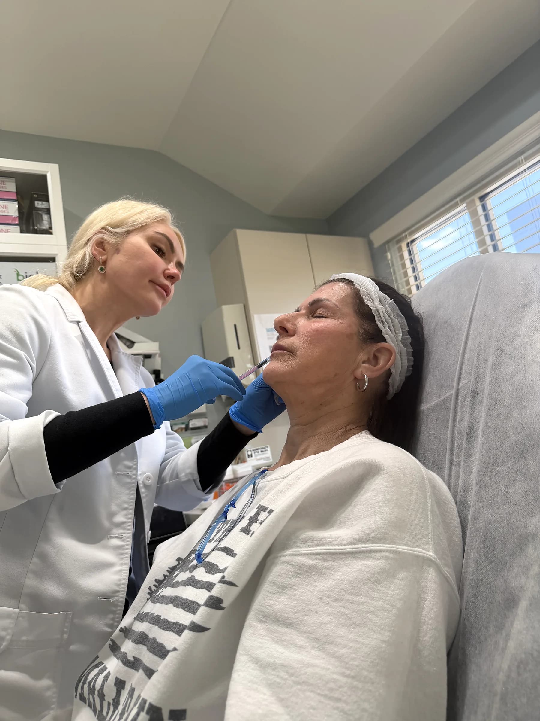Alina McCann assessing volume loss in the cheeks