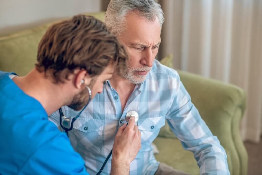 Healthcare professional using a stethoscope to assess a patient's heart health during a check-up, emphasizing the importance of heart health assessments.