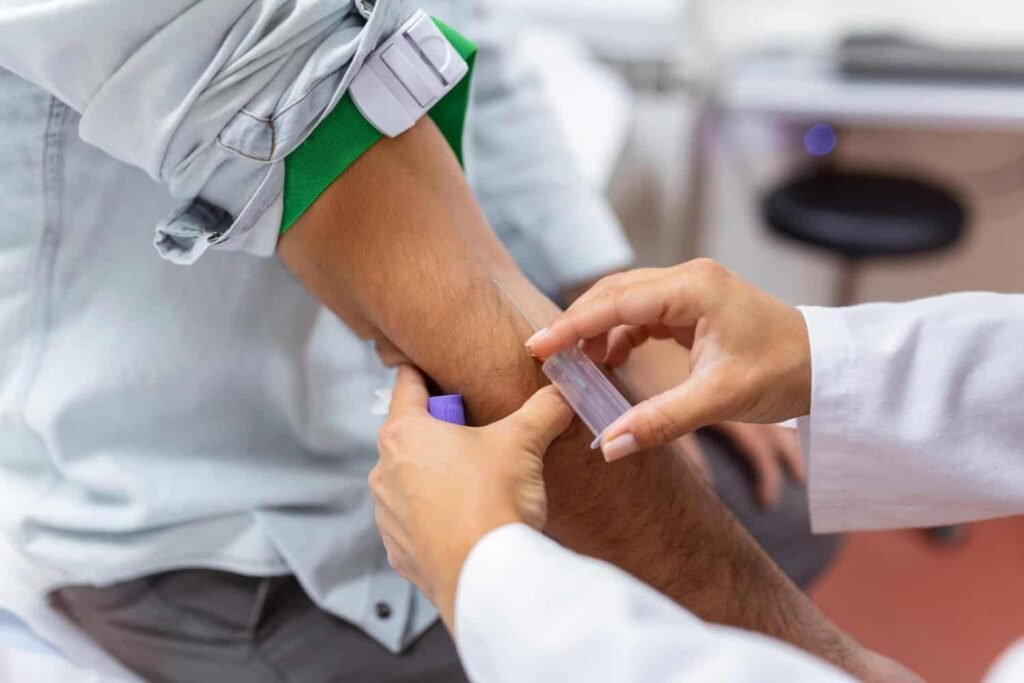 Patient receiving a blood draw for liver health assessment at 4Ever Young STL MedSpa, focusing on Fibro Test and related blood tests.