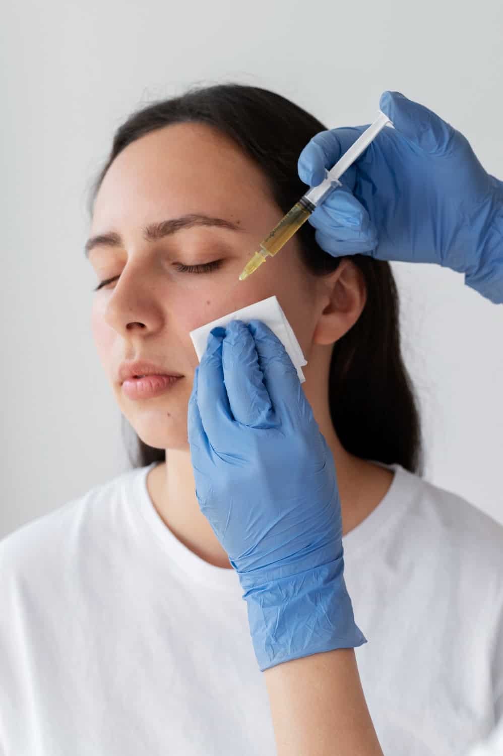 Person receiving Platelet Rich Plasma (PRP) treatment for skin rejuvenation, with gloved hands administering the procedure, emphasizing aesthetic wellness and collagen stimulation.